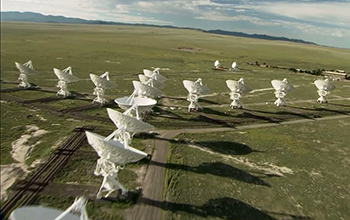 aerial view of large telescopes in a grassy area